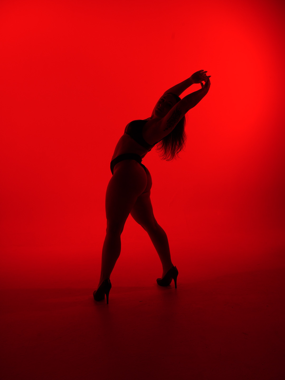 Paige Jade fully framed in a standing heels dance pose