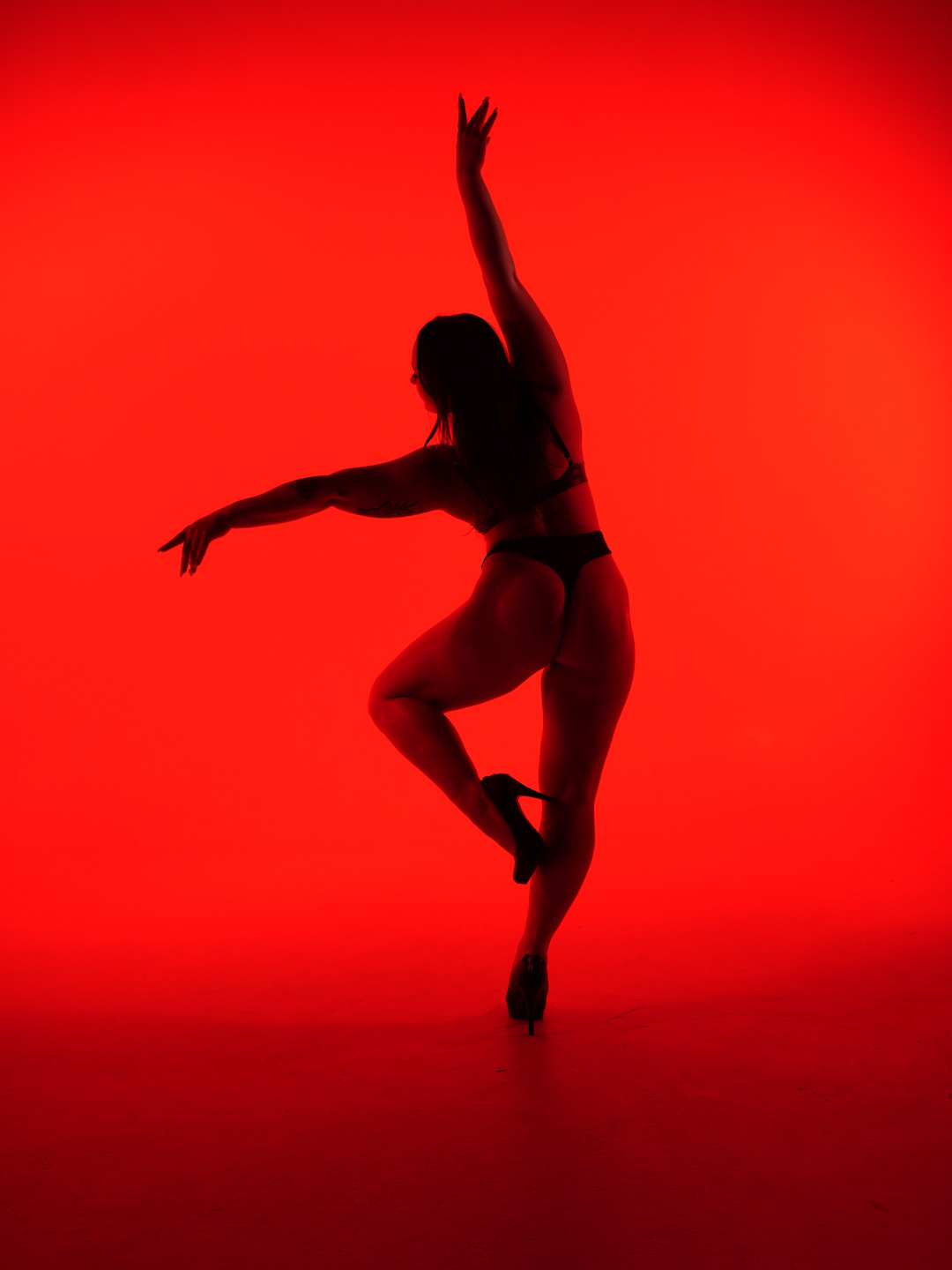Paige Jade fully framed in an expressive standing heels pose